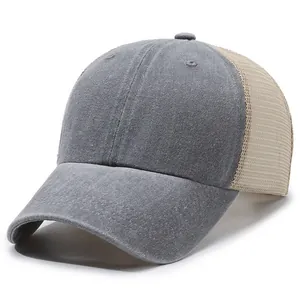 Detailed view of the washed gray distressed fabric and beige mesh on this baseball cap.
