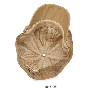 Detailed interior view of a tan mesh newsboy cap showing breathable structure and lining