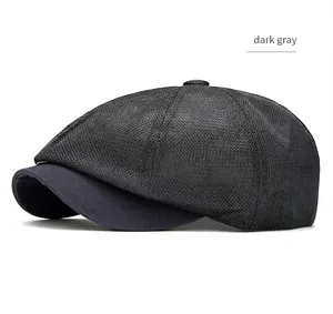 Close-up profile of a dark gray mesh newsboy cap featuring breathable fabric and curved brim