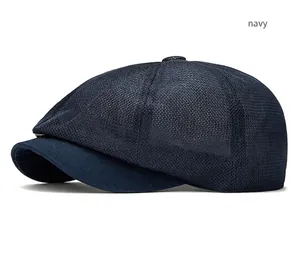 Close-up detail of a navy blue mesh newsboy cap showing breathable summer texture