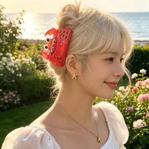 Detail of oversized red lobster hair claw clip on model in a seaside garden setting