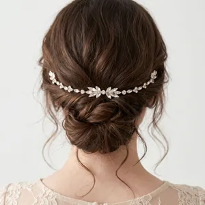 Close-up view of a French vine rhinestone hair comb styled on a bridal bun hairstyle