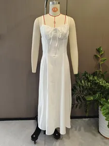Elegant white midi A-line dress with tie-front detail shown on professional mannequin