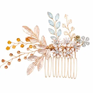 Elegant gold bridal hair comb with crystal flowers and leaves for wedding hairstyles.