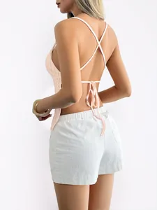 Detailed back view of a light pink Y2K backless halter top with cross-back straps