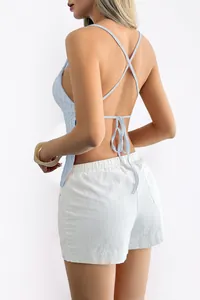 Back view of light blue backless halter top with crisscross straps and white shorts
