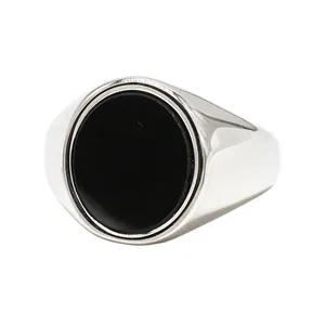 Minimalist men's titanium steel ring featuring a large oval black onyx-style stone.