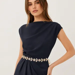 Close-up of elegant flower leaf rhinestone belt on a navy dress for wedding banquets