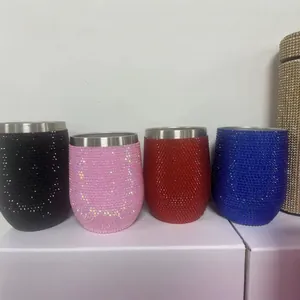 Macro detail of four rhinestone-encrusted stainless steel wine tumblers in assorted colors.