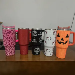 Detail of rhinestone-studded insulated tumblers with various character and holiday patterns
