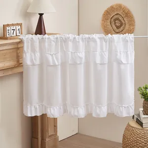 Detail view of white ruffled cake skirt curtain with elegant layered design for home decor.