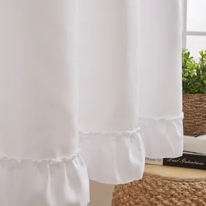 Close-up detail of elegant white ruffled hem curtains with textured fabric finish