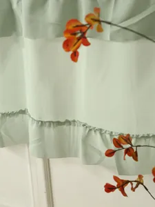 Detailed view of mint green window curtain featuring multi-layered ruffle cake skirt design