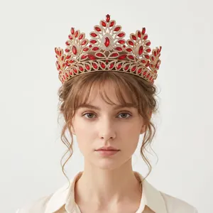 Elegant baroque vintage crown with red crystals worn by a model on a white background.