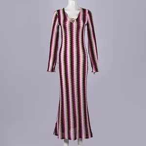 Close-up view of the chic zigzag pattern and metallic V-neck detail on a slim knit dress.