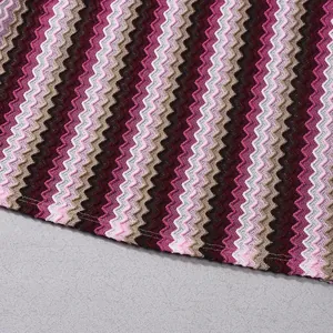 Detailed macro view of magenta and pink zig-zag knit pattern on a slim-fit dress.