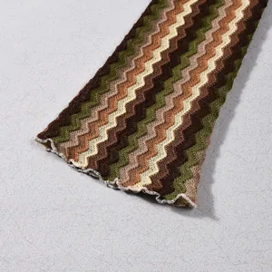 Close-up detail of yarn-dyed knit dress featuring a zigzag pattern and lettuce edge hem line.
