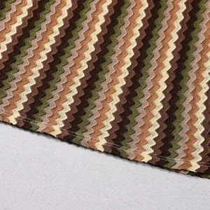 Macro detail of multi-colored zigzag knit pattern on women's autumn long-sleeve dress