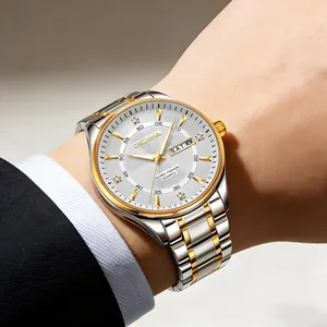 Close-up of men's two-tone stainless steel watch with double calendar on wrist
