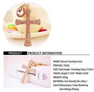 Detailed view of a sparkling rhinestone cross keychain featuring a water-drop crystal charm
