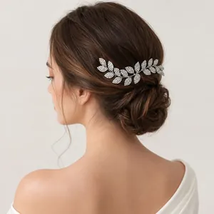 Elegant silver-toned rhinestone leaf hair comb detail styled in a professional bridal updo