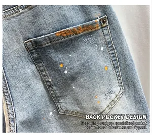 Detail of men's high street denim shorts with hand-painted paint splatters on back pocket
