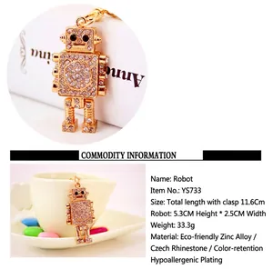 Close-up of golden robot keychain with sparkling rhinestones and product dimensions