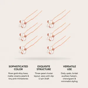 Detailed view of six rose gold U-shaped hairpins featuring three-pearl clusters