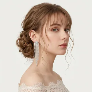 Close-up of elegant silver tassel earrings with sparkling crystals for bridal wedding.