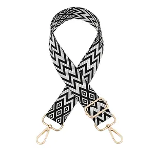 Detail view of adjustable woven bag strap with black and white geometric chevron patterns.