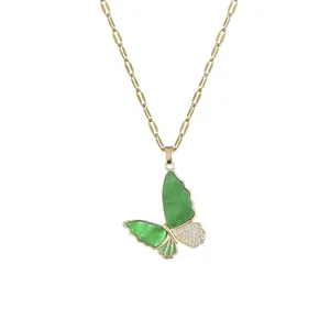 Elegant gold paperclip chain necklace with a green butterfly pendant and pave stone accents