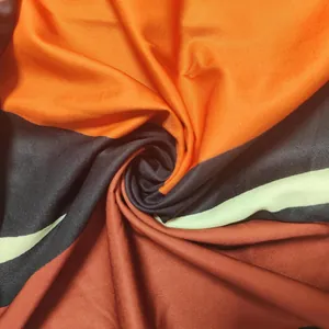 Detailed macro view of soft printed fabric with vibrant orange and black blocks