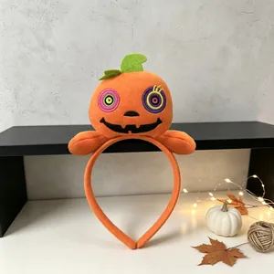 Plush Halloween pumpkin headband featuring festive embroidery for party decorations.