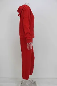 Detailed side view of women's red hooded sweatshirt and joggers athletic tracksuit set