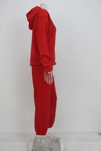 Side profile view of a vibrant red hooded sweatshirt and matching jogger pants sports set.