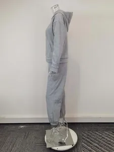 Side profile detail of minimalist gray hooded sweatshirt and sweatpants set on mannequin
