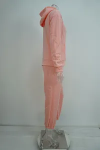 Side view of pink hooded sweatshirt and matching sweatpants set on mannequin