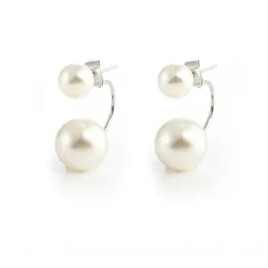 Close-up detail of elegant cream white front-back pearl stud earrings with silver metal posts