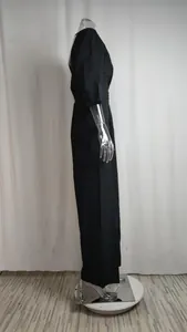 Side view detail of this elegant black v-neck wide-leg jumpsuit on a clear mannequin