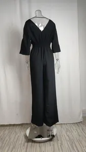 Back view detail showing the elegant V-neck and elastic waist of this black jumpsuit
