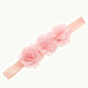 Pink baby elastic headband with three layered chiffon flowers on white background