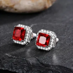Close-up of exquisite square red gemstone stud earrings with pavé white zircon halo setting