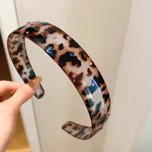 Detail of vintage tortoiseshell acrylic headband with sparkling colorful rhinestones
