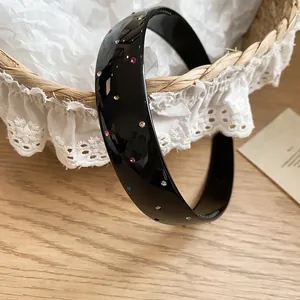 Detailed view of vintage black acrylic headband with colorful sparkling rhinestones