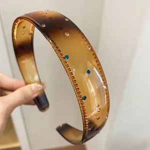 Detailed view of vintage brown acrylic headband adorned with colorful sparkling rhinestones