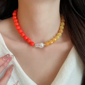 Detailed shot of a dopamine style acrylic bead necklace featuring a white baroque pearl