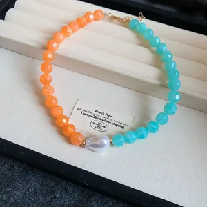Dopamine style acrylic necklace featuring vibrant orange and blue beads with a pearl center