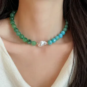 Detailed view of dopamine style acrylic bead necklace with a baroque pearl on model neck.