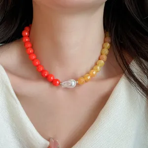 Close-up of a dopamine style acrylic beaded necklace with a central baroque pearl