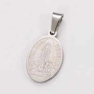 Detailed macro view of an oval stainless steel pendant featuring a religious relief carving